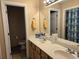 Bathroom with a double sink vanity, large mirror, and a view of the toilet and shower at 938 Fox Hollow Rd., Conway, SC 29526