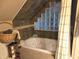 Stylish bathroom with a soaking tub and glass block window, creating a serene retreat at 938 Fox Hollow Rd., Conway, SC 29526