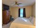 Bedroom with a spacious bed, wooden armoire, and large window with dark curtains at 938 Fox Hollow Rd., Conway, SC 29526