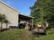 View of garage and carport with lawn equipment at 938 Fox Hollow Rd., Conway, SC 29526