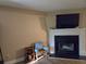 Living room showcasing a fireplace with a mounted TV, accent seating and wood floors at 938 Fox Hollow Rd., Conway, SC 29526