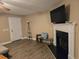 Living room featuring a fireplace with TV, wood-style flooring, and a doorway at 938 Fox Hollow Rd., Conway, SC 29526