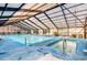 Spacious indoor pool area with a hot tub, lounge chairs, and ample natural light at 501 Maison Dr. # B10, Myrtle Beach, SC 29572