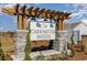 Elegant community sign at Carrington Woods with stone accents and decorative wooden pergola at 543 Duvall St., Longs, SC 29568