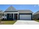 Charming single-story home featuring blue siding, a red door, and an attached two-car garage at 543 Duvall St., Longs, SC 29568