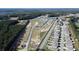 An aerial view showcases a planned community with a mix of homes and undeveloped lots at 559 Duvall St., Longs, SC 29568