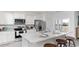 Modern eat-in kitchen featuring white cabinets, stainless appliances, and granite countertops with bar seating at 559 Duvall St., Longs, SC 29568