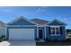 Charming blue single-Gathering home with a one-car garage and a well-manicured lawn under a bright blue sky at 573 Duvall St., Longs, SC 29568