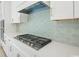 Close-up of modern kitchen's stainless steel gas range and white cabinetry with sleek hardware at 1035 Milford Way, Myrtle Beach, SC 29588
