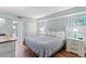 Cozy bedroom with light blue walls, a queen-sized bed, wood floors, and serene decor providing a comfortable retreat at 2000 N Ocean Blvd. # 1612, Myrtle Beach, SC 29577