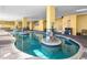 Inviting indoor pool area featuring a unique layout, surrounded by columns and brick detailing at 2000 N Ocean Blvd. # 1612, Myrtle Beach, SC 29577