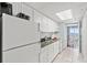 Bright kitchen featuring white appliances and cabinets, black countertops, and a dining area with ocean view at 2000 N Ocean Blvd. # 1612, Myrtle Beach, SC 29577