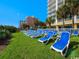 Relaxing outdoor lawn chairs with palm trees and an ocean view at 2000 N Ocean Blvd. # 1612, Myrtle Beach, SC 29577