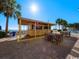 Outdoor bar with seating surrounded by palm trees, lawn chairs and a view of the ocean at 2000 N Ocean Blvd. # 1612, Myrtle Beach, SC 29577