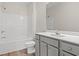 Clean bathroom with a shower, toilet, sink, and gray cabinets at 371 Lifestyle Court, Surfside Beach, SC 29575