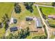 Expansive aerial view of a property featuring multiple structures surrounded by green lawns and mature trees at 3747 Bakers Chapel Rd., Aynor, SC 29511