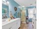 Bright blue bathroom featuring a single sink vanity with framed mirror and enclosed shower stall at 3747 Bakers Chapel Rd., Aynor, SC 29511