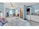 Spacious bedroom with soft blue walls featuring a ceiling fan and bonus doll display area at 3747 Bakers Chapel Rd., Aynor, SC 29511