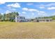 Well-kept home with large front yard and a backyard pergola, plus a view of a workshop and garages at 3747 Bakers Chapel Rd., Aynor, SC 29511
