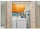 Bright laundry room with modern washer, dryer, and storage at 3747 Bakers Chapel Rd., Aynor, SC 29511