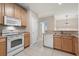 Modern kitchen with white appliances and wood cabinets at 5822 Longwood Dr. # 202, Murrells Inlet, SC 29576