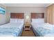 Hotel bedroom with two beds and a table between them at 6900 N Ocean Blvd. # 812, Myrtle Beach, SC 29572