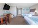 Bright hotel suite bedroom with two beds, workspace, and beach-themed decor at 6900 N Ocean Blvd. # 812, Myrtle Beach, SC 29572