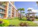 Exterior view of the property with palm trees, picnic tables, and lush green lawn, providing a relaxing outdoor space at 6900 N Ocean Blvd. # 812, Myrtle Beach, SC 29572