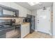 A compact kitchen featuring black appliances and white cabinetry at 6900 N Ocean Blvd. # 812, Myrtle Beach, SC 29572