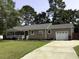 Charming home featuring a well-manicured lawn, front porch and an attached garage at 104 Sprucewood Ct., Myrtle Beach, SC 29588