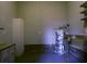 Garage with shelving, cabinets, and water heater wrapped in plastic for protection at 104 Sprucewood Ct., Myrtle Beach, SC 29588