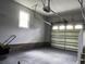 Spacious garage with garage door and natural light from the window at 104 Sprucewood Ct., Myrtle Beach, SC 29588