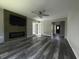 Bright living room featuring hardwood floors, ceiling fan, fireplace and access to sunroom at 104 Sprucewood Ct., Myrtle Beach, SC 29588