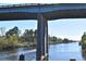 Picturesque waterway view under a bridge, offering serene waterfront living with natural beauty and tranquility at 104 Sprucewood Ct., Myrtle Beach, SC 29588