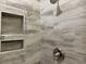 Shower with decorative stone-look tile, shower head, and a built-in toiletry niche at 3131 Tiger Tail Rd., Conway, SC 29526