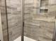 Modern bathroom with a glass shower and wood-look tile surround and built in niche at 3131 Tiger Tail Rd., Conway, SC 29526