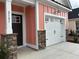 A view of the house address number and garage, with stone accents, and modern exterior lighting at 3131 Tiger Tail Rd., Conway, SC 29526