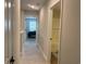 Hallway with carpeted floors connecting to bathroom with tub and bedroom with natural light at 3131 Tiger Tail Rd., Conway, SC 29526