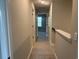 Hallway with carpeted floors and neutrally painted walls leading to various rooms at 3131 Tiger Tail Rd., Conway, SC 29526