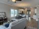 Open-concept living room and kitchen featuring sleek wood floors and neutral color palette at 3131 Tiger Tail Rd., Conway, SC 29526