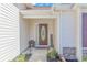 Inviting front porch with a decorative glass door, 'Welcome' sign, and manicured landscaping at 3412 Holly Loop, Conway, SC 29527
