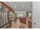 Traditional kitchen featuring granite countertops, stainless steel appliances, and brown cabinets overlooking a dining area at 3412 Holly Loop, Conway, SC 29527