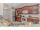 Traditional kitchen with granite countertops, stainless steel appliances, and brown wood cabinets at 3412 Holly Loop, Conway, SC 29527
