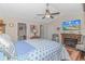 Cozy primary bedroom featuring hardwood floors, a ceiling fan, and a fireplace at 3412 Holly Loop, Conway, SC 29527