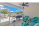 Relaxing patio with wicker furniture, ceiling fan, outdoor grill, and a peaceful waterfront view at 3412 Holly Loop, Conway, SC 29527