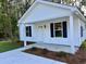 Charming single-story home with a front porch, white siding, and dark shutters at 74 Greentown Rd., Georgetown, SC 29440