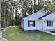 Exterior view of a charming house with a well-maintained lawn surrounded by lush trees at 74 Greentown Rd., Georgetown, SC 29440