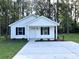 Charming single-story home with white siding, black shutters, and a well-manicured front yard at 74 Greentown Rd., Georgetown, SC 29440