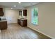 Bright and spacious kitchen area with stainless steel appliances, wood cabinetry and laminate flooring at 74 Greentown Rd., Georgetown, SC 29440