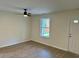Living room featuring sleek laminate flooring, a modern ceiling fan, and a bright, airy atmosphere at 74 Greentown Rd., Georgetown, SC 29440